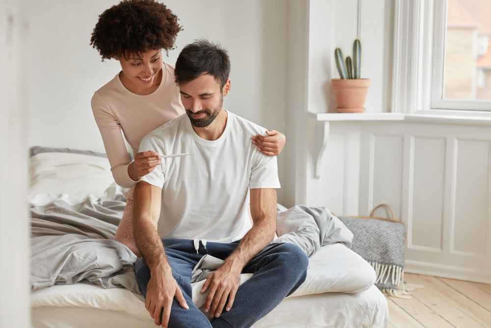 happy young african american woman shows positive pregnancy test her husbnad